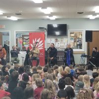 Tuvan musical group with BMS students as audience on campus